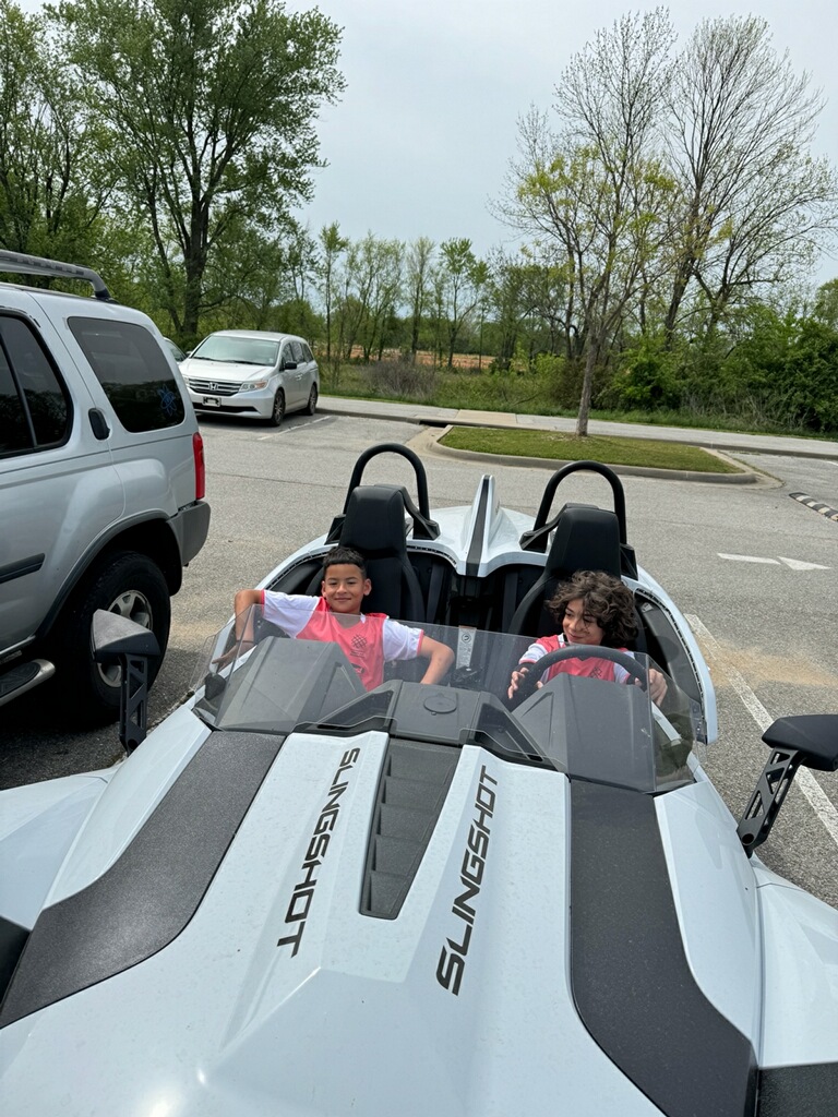 Two young boys parked in the Slingshot